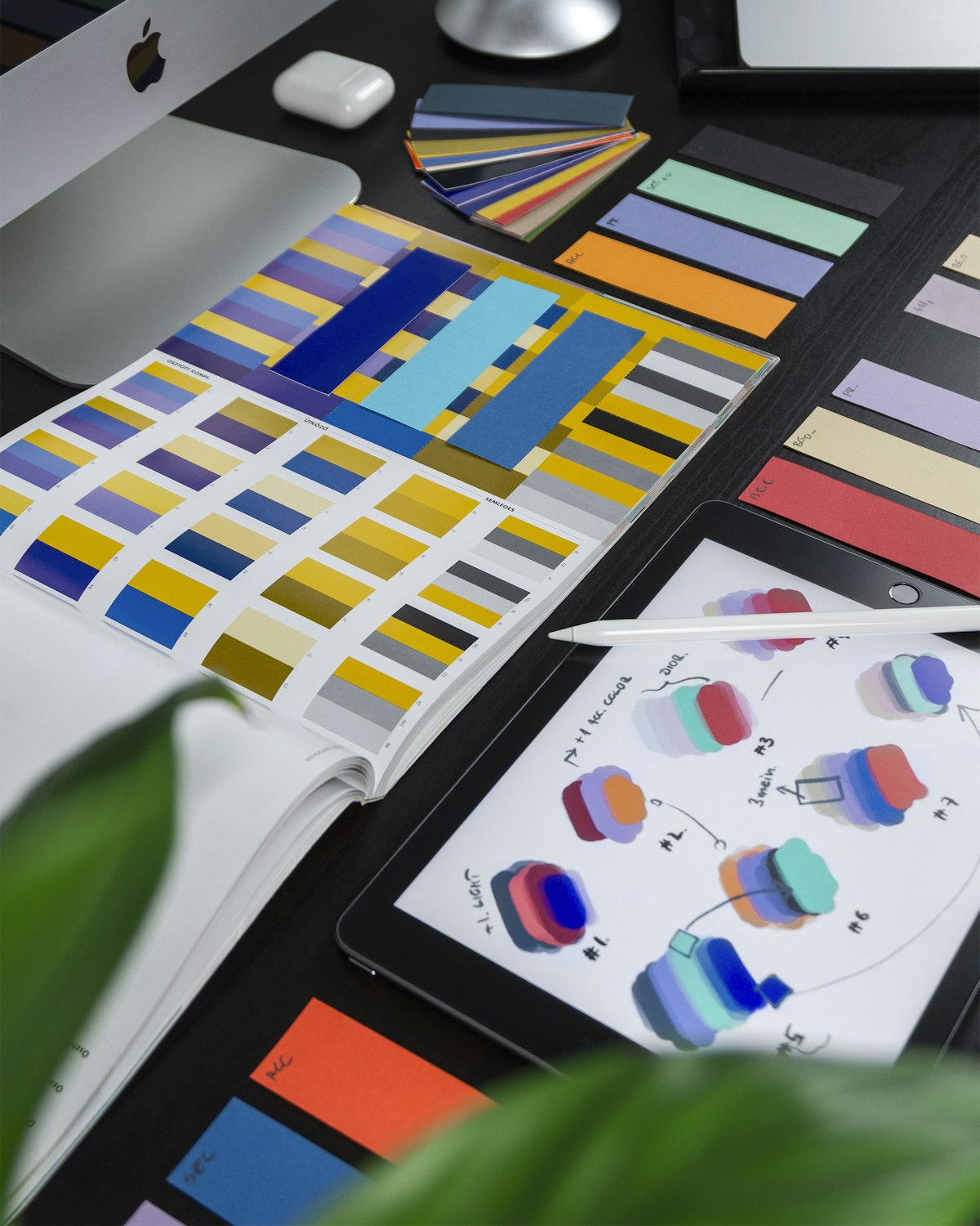Printed design and branding materials on a studio desk